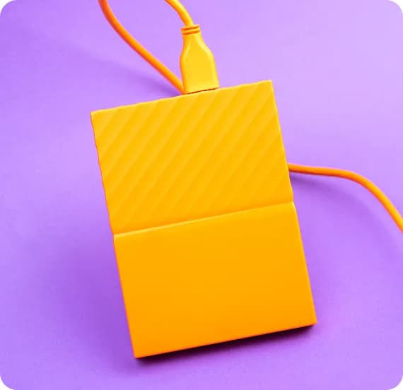 A yellow box with a cord hanging out of it.