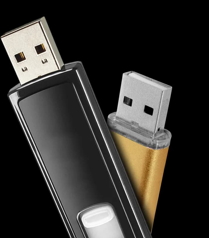 A black USB flash drive with a gold USB plug.