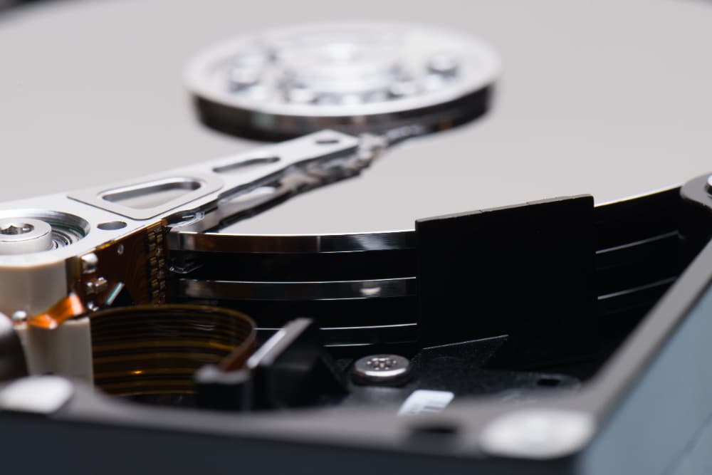 A close up of a hard drive with a screwdriver in it.